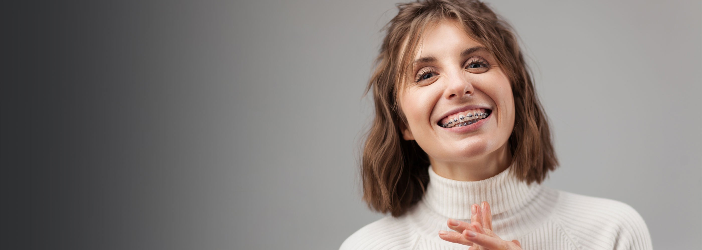 Orthodontic patient wearing a fixed orthodontic appliance